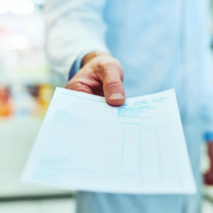 A doctor handing over a script