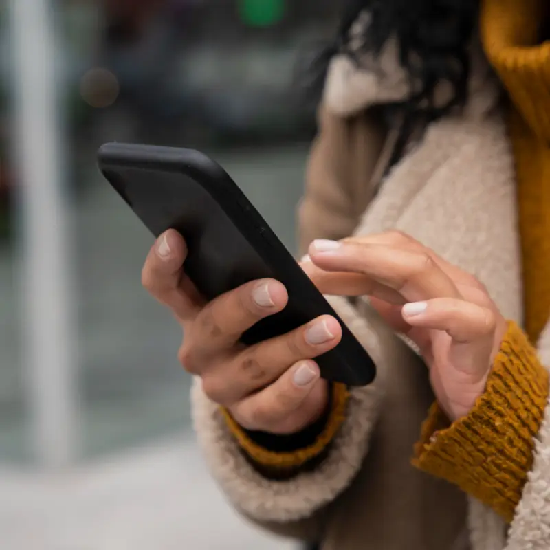 A woman messaging on a mobile phone