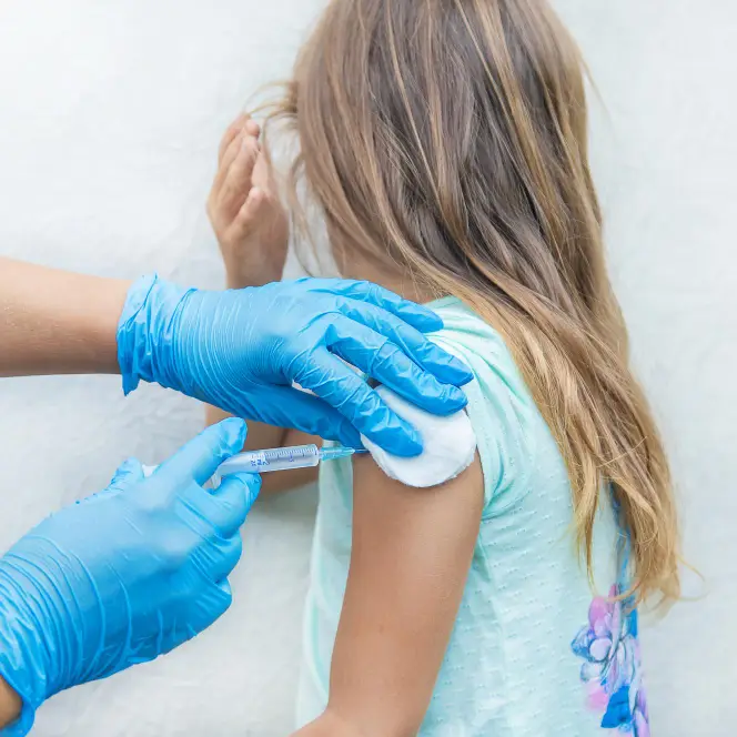 A young girl receiving a flu vaccination